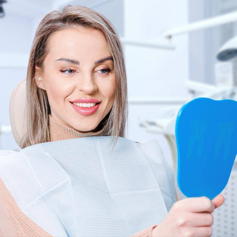 happy-attractive-woman-looking-at-her-teeth-in-mir-2022-11-29-20-20-45-utc